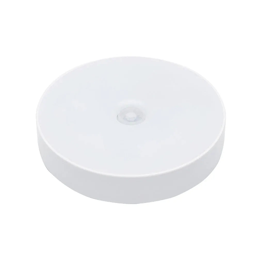 Small white round motion sensing LED night light with USB charging port