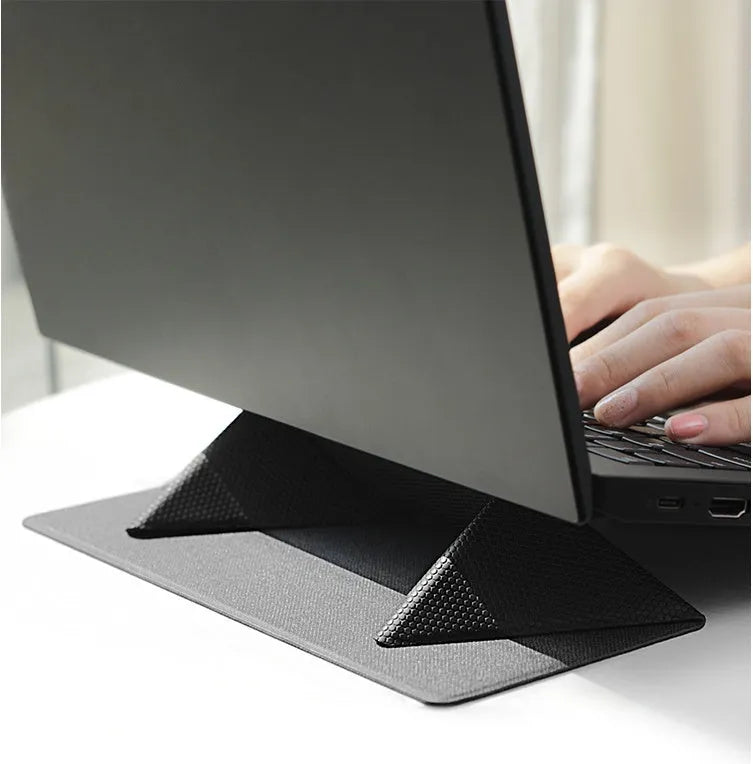 Blue portable laptop cooling bracket with foldable design on a wooden table.