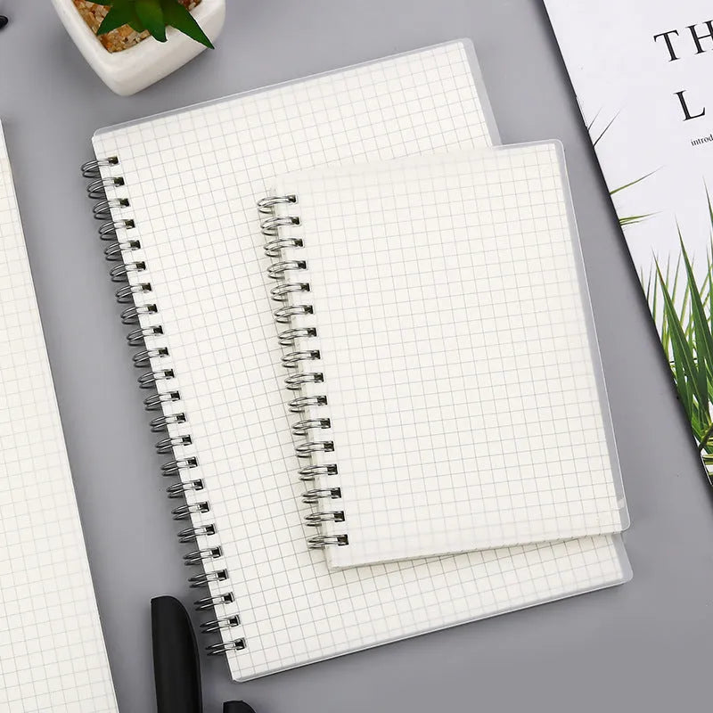 Creative spiral notebook open on dot grid page, showing A5 size and PP matte cover.