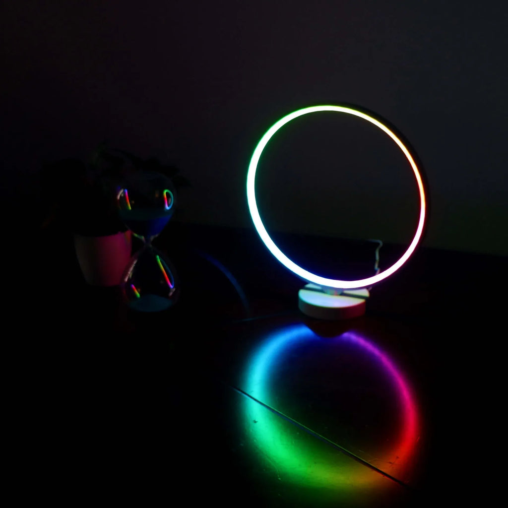White full moon lamp with remote control on table showing adjustable colour temperature settings