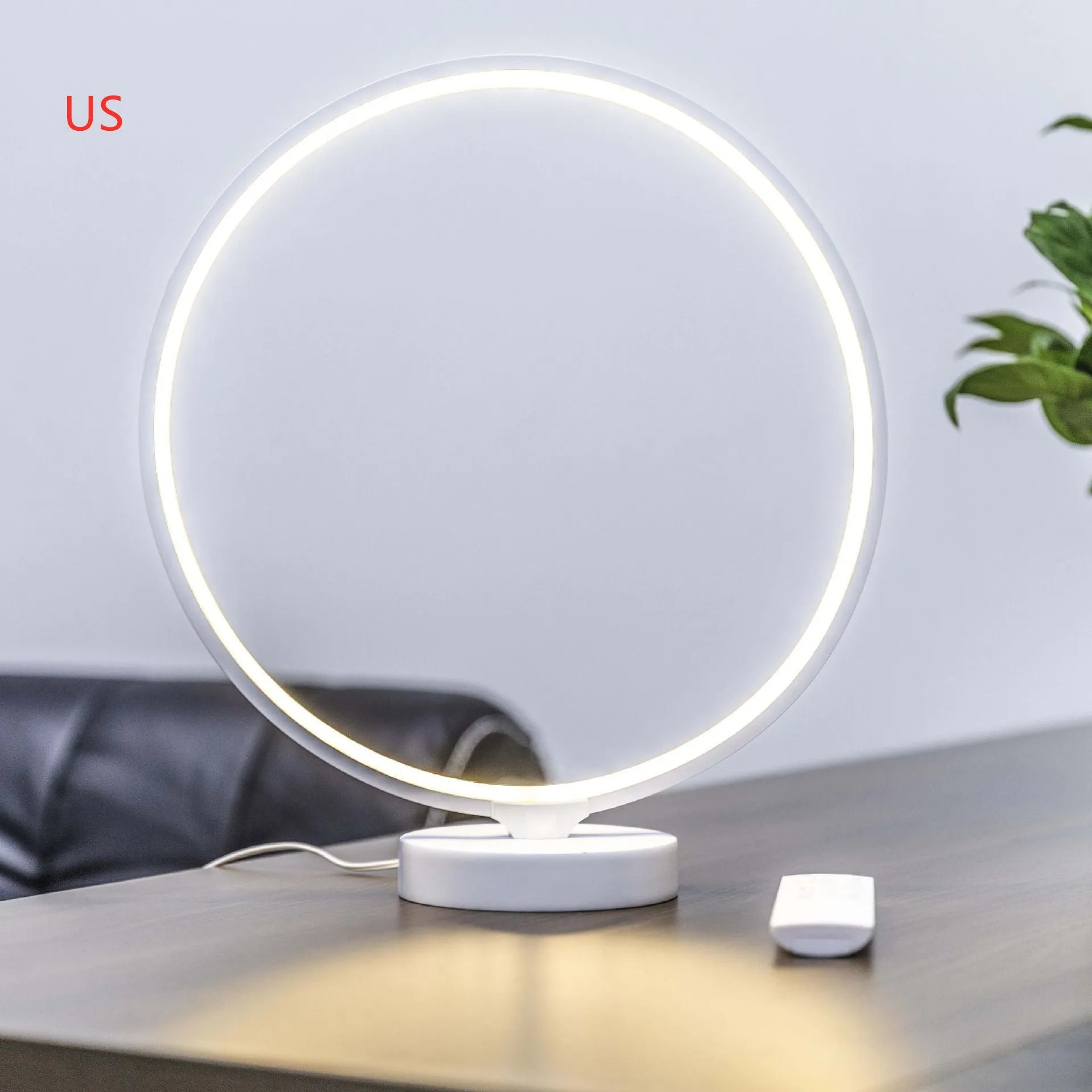 White full moon lamp with remote control on table showing adjustable colour temperature settings