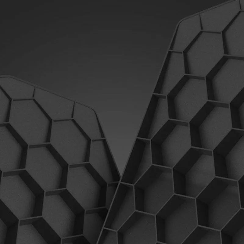 Black three-dimensional geometric mouse pad with honeycomb support structure, 35.8x21x2.8cm, on a desk
