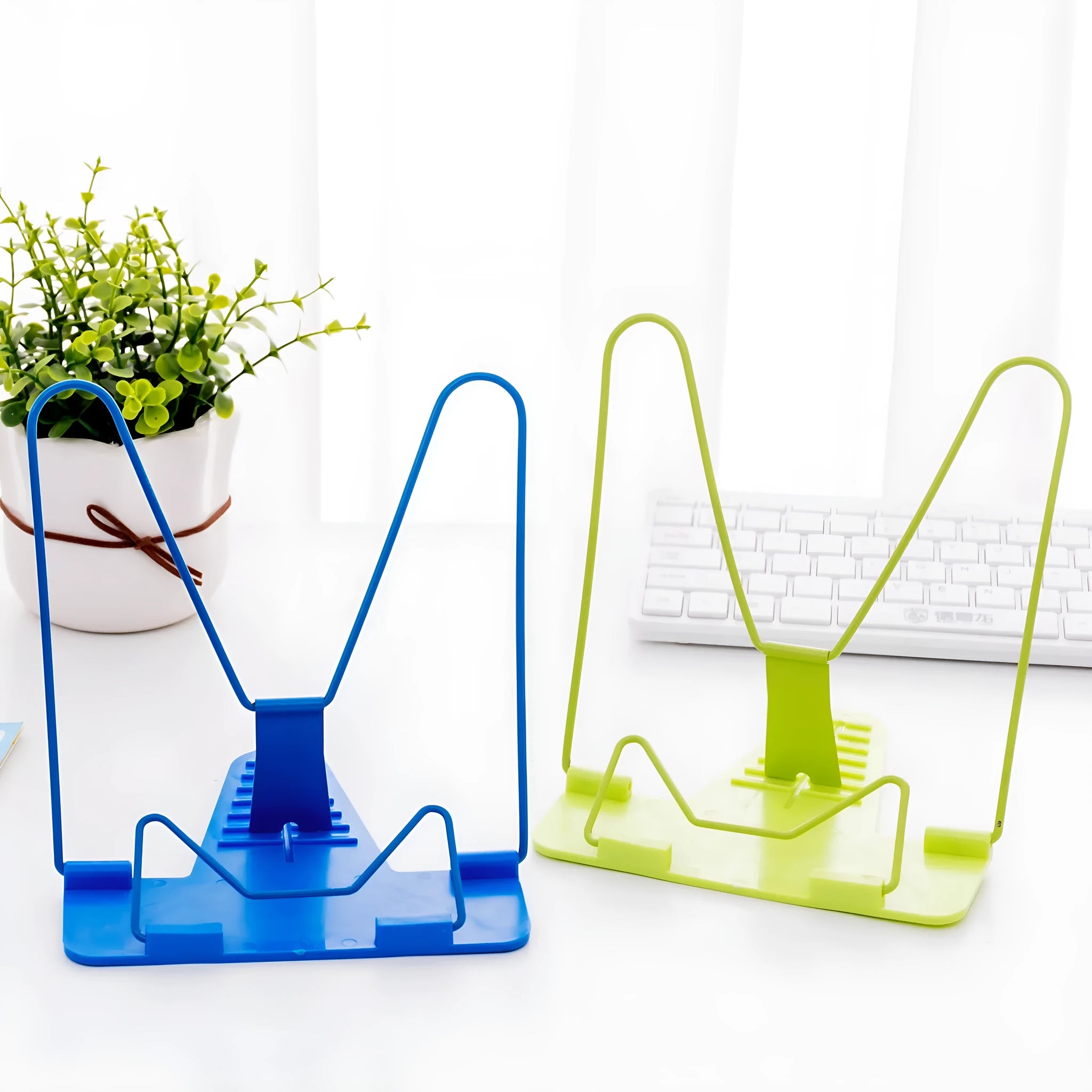 Red, green, and blue metal and plastic reading frame book stand measuring 16 by 17.5 cm