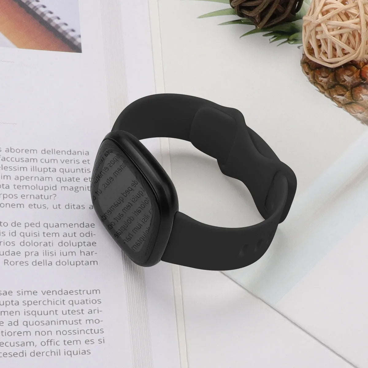 Fitbit Versa3 smart watch with a black TPU silicone replacement strap on a wrist.