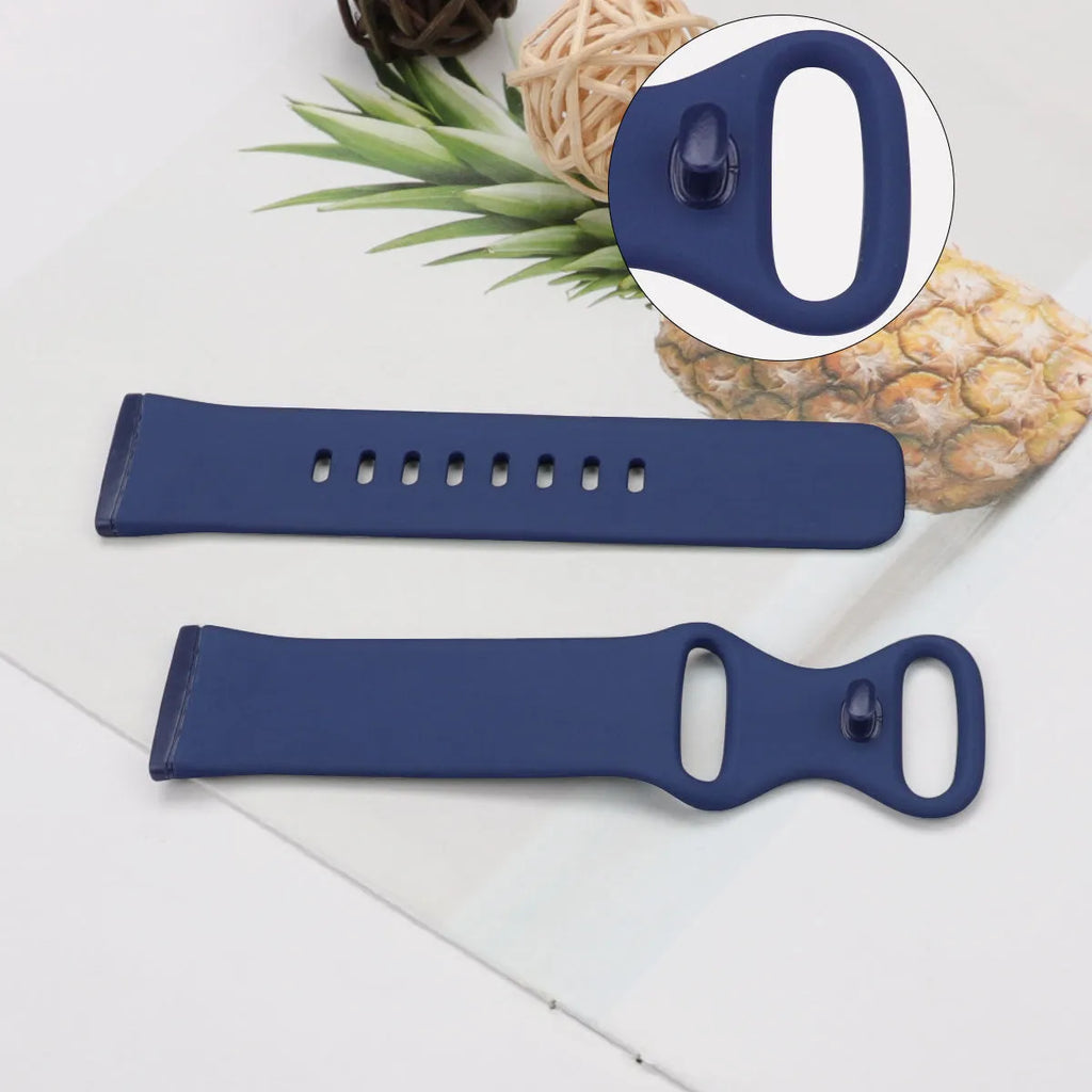 Fitbit Versa3 smart watch with a black TPU silicone replacement strap on a wrist.