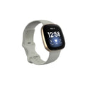 Fitbit Versa3 smart watch with a black TPU silicone replacement strap on a wrist.