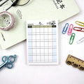 Compact A6 work plan diary notebook open, showing weekly planning pages.