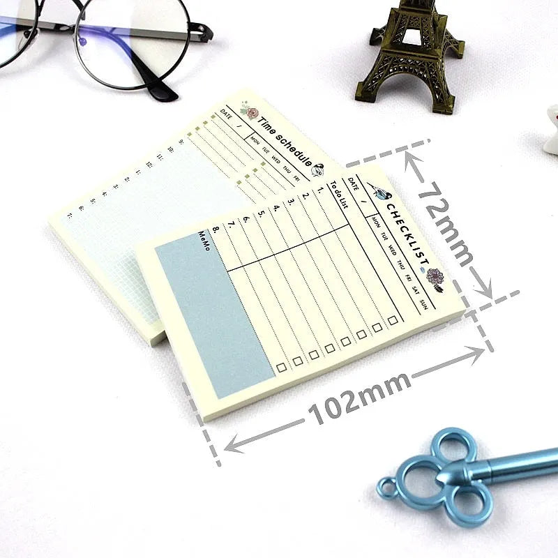 Compact A6 work plan diary notebook open, showing weekly planning pages.