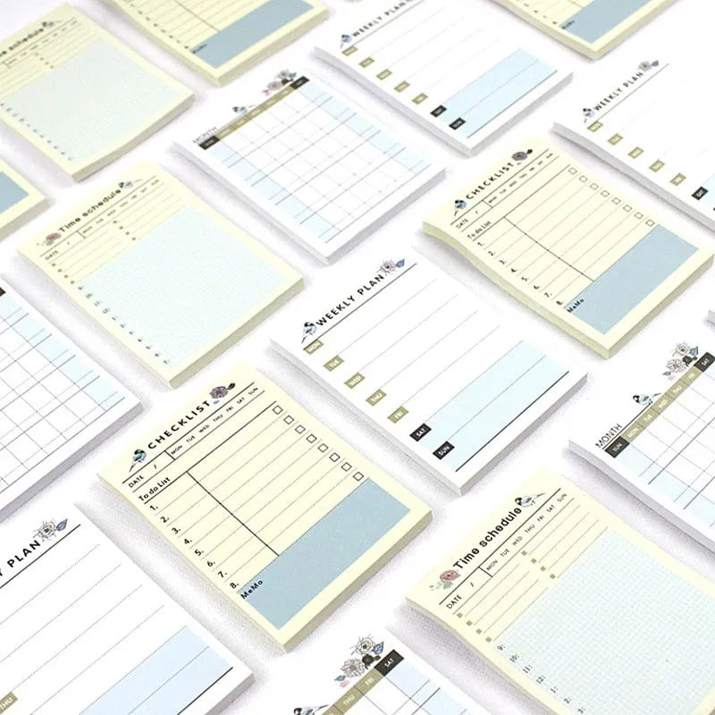 Compact A6 work plan diary notebook open, showing weekly planning pages.