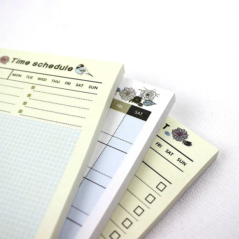 Compact A6 work plan diary notebook open, showing weekly planning pages.