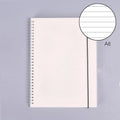 B5 coil grid notebook with Pp cover, open showing lined pages on a desk