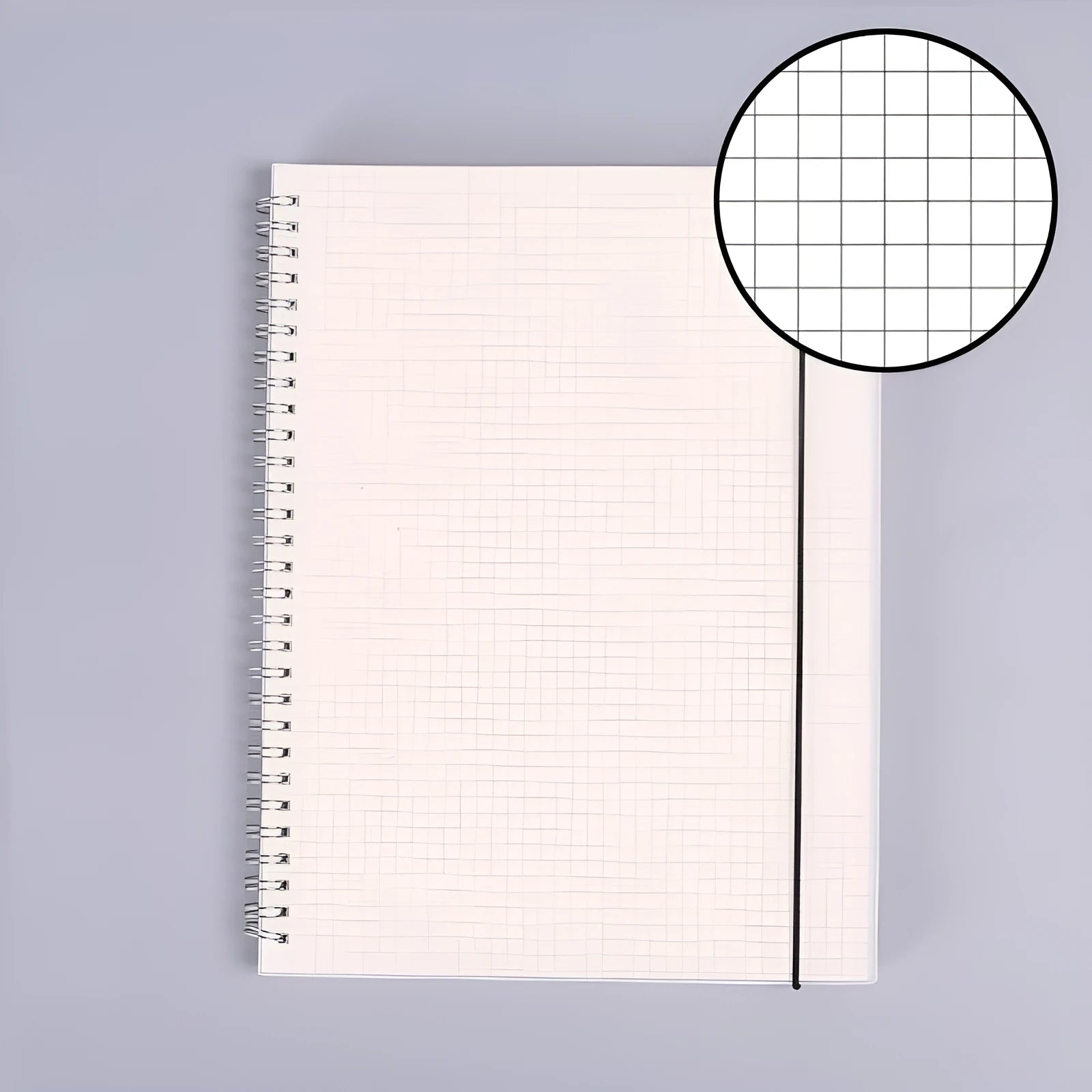 B5 coil grid notebook with Pp cover, open showing lined pages on a desk