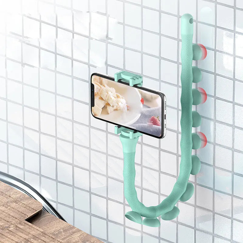 Black flexible lazy bracket mobile phone holder with long arm and suction cup base on a desktop