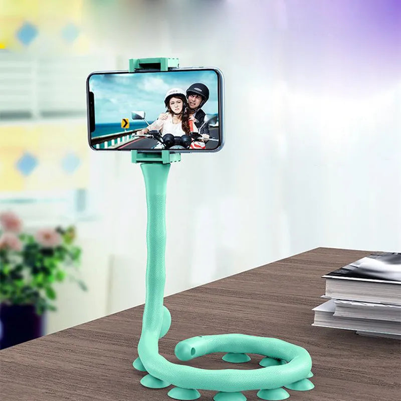 Black flexible lazy bracket mobile phone holder with long arm and suction cup base on a desktop
