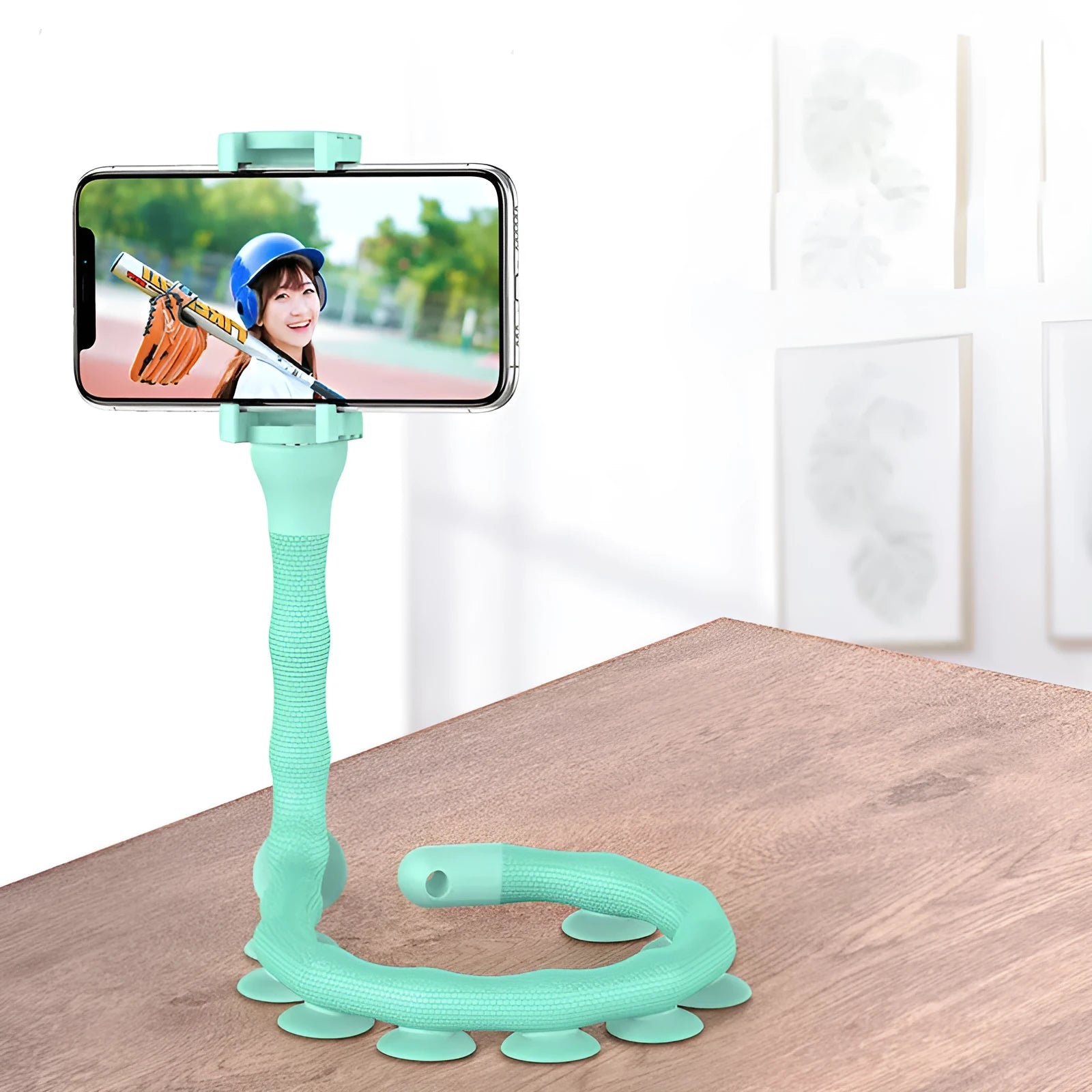 Black flexible lazy bracket mobile phone holder with long arm and suction cup base on a desktop