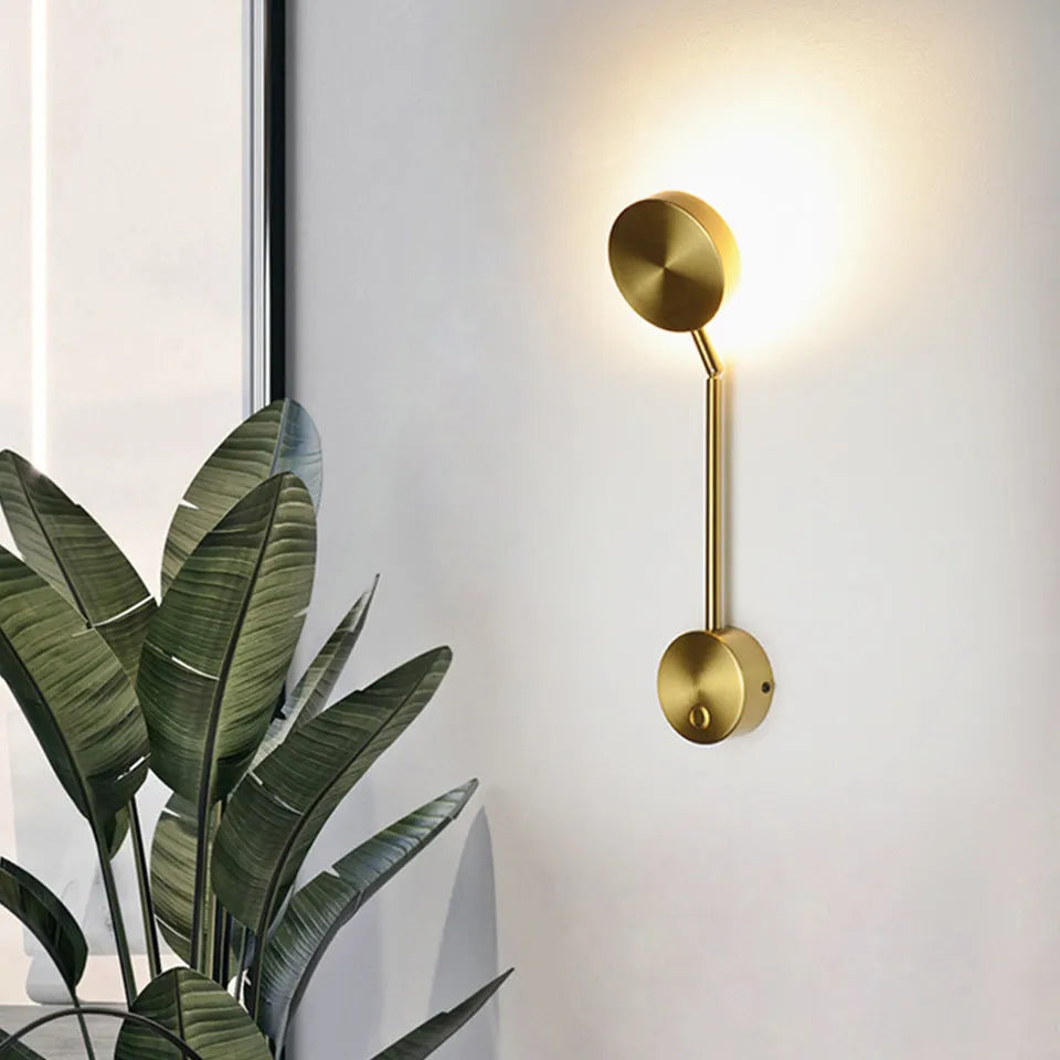 Golden square LED wall lamp with acrylic shade mounted on a wall