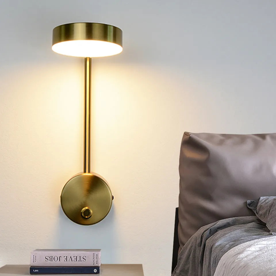 Golden square LED wall lamp with acrylic shade mounted on a wall