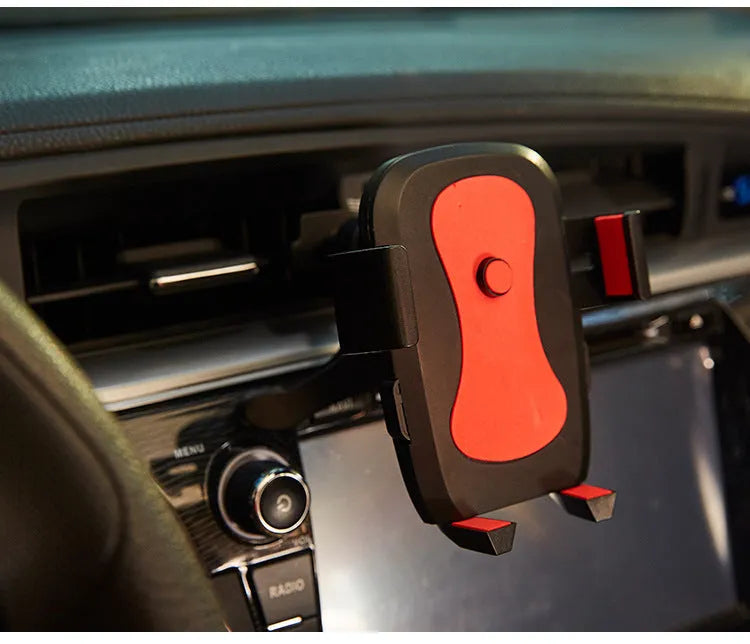 Black ABS plastic car phone holder clipped onto car vent with smartphone in landscape orientation