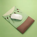 Green kiwi fruit design on a cloth mouse pad with a thick, integrated silicone wrist support cushion.