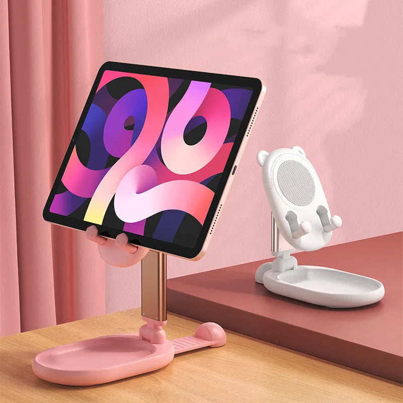 Blue adjustable desk phone holder with mirror, holding an iPhone at an angle on a wooden desk