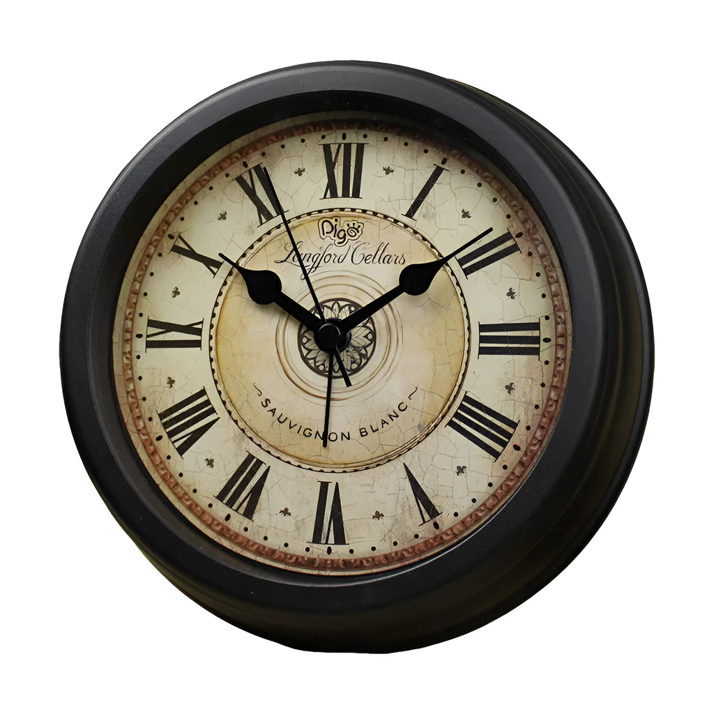 Round retro desk alarm clock with a white dial on a wooden surface.