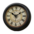 Round retro desk alarm clock with a white dial on a wooden surface.