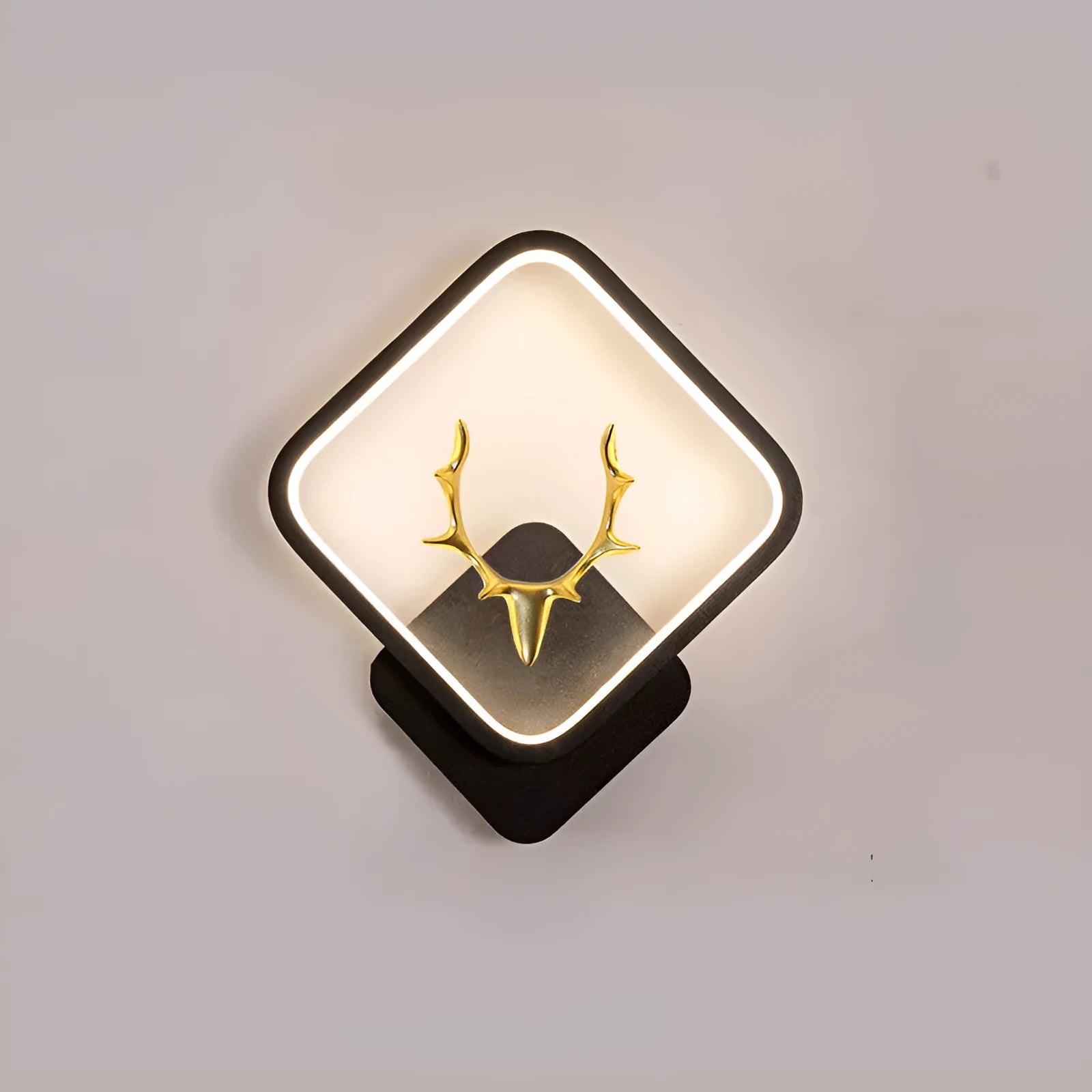 Modern deer antler design wall lamp with remote control on a plain wall, showing white and black colour options.