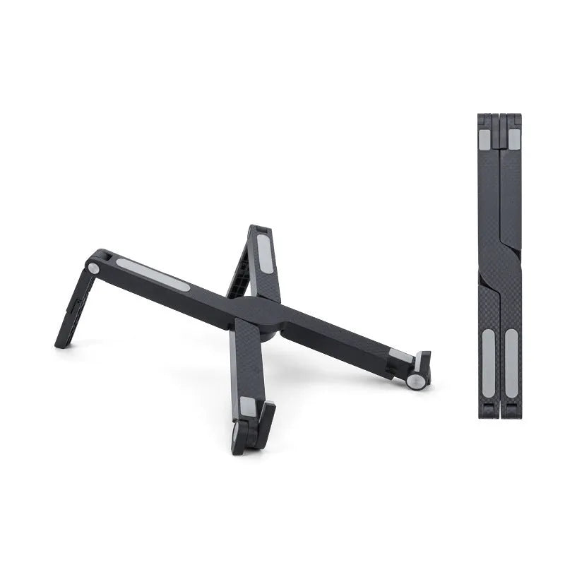 Folding aluminium alloy laptop stand in grey on a wooden desk, showing adjustable width and non-slip pads