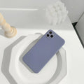 Simple solid colour silicone phone case for iPhone in pink, blue, and antique white options.
