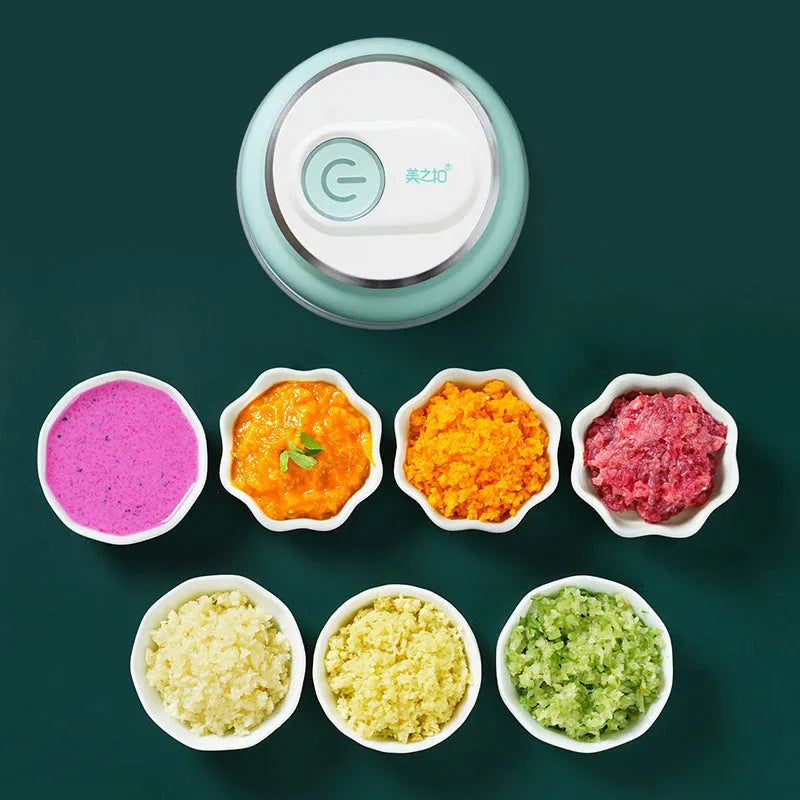 Electric food chopper with transparent cup and stainless steel blade on kitchen counter