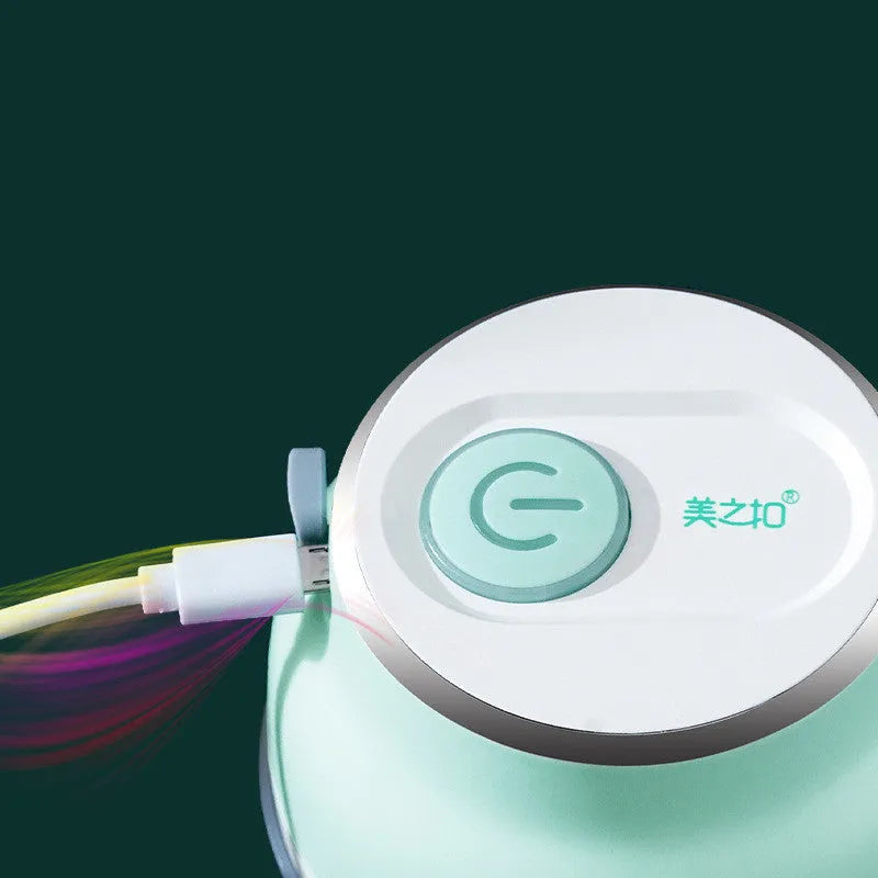 Electric food chopper with transparent cup and stainless steel blade on kitchen counter
