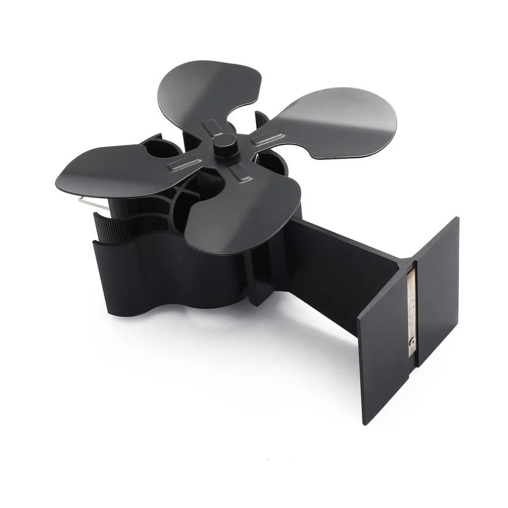 Black Yotsuba style thermodynamic fireplace fan sitting on a hearth.