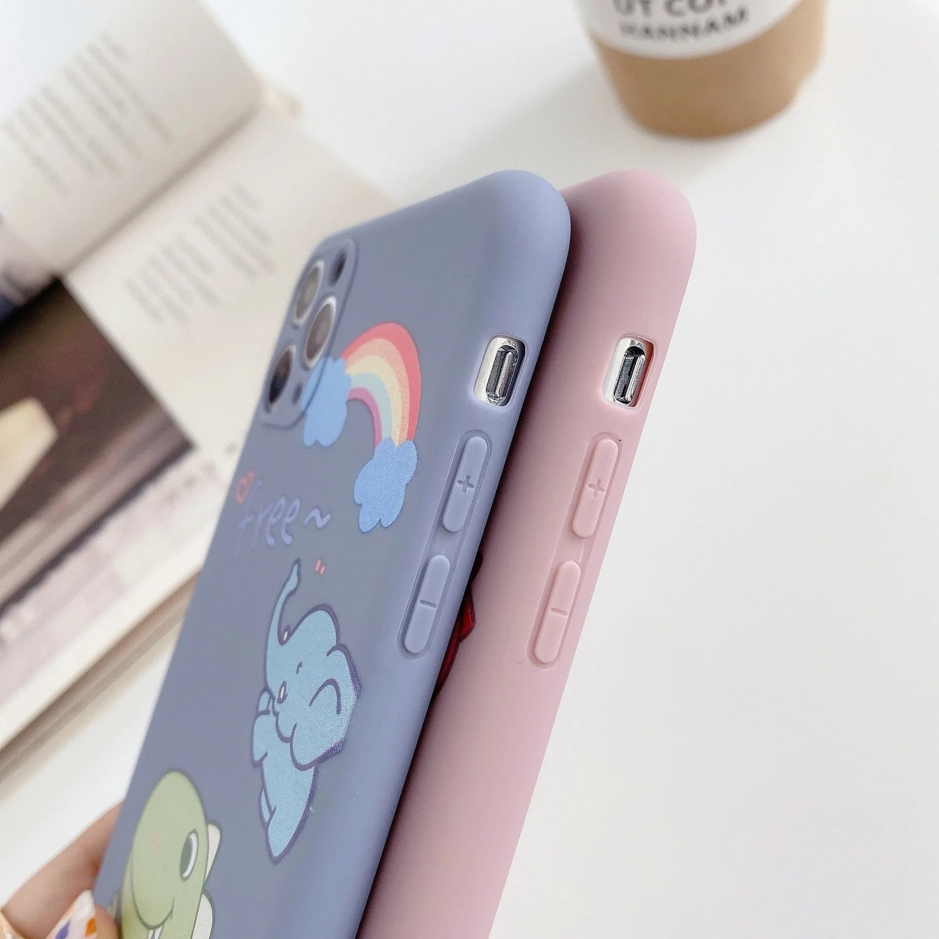 Blue TPU iPhone case with printed dinosaur cartoon design shown on iPhone 12 mini