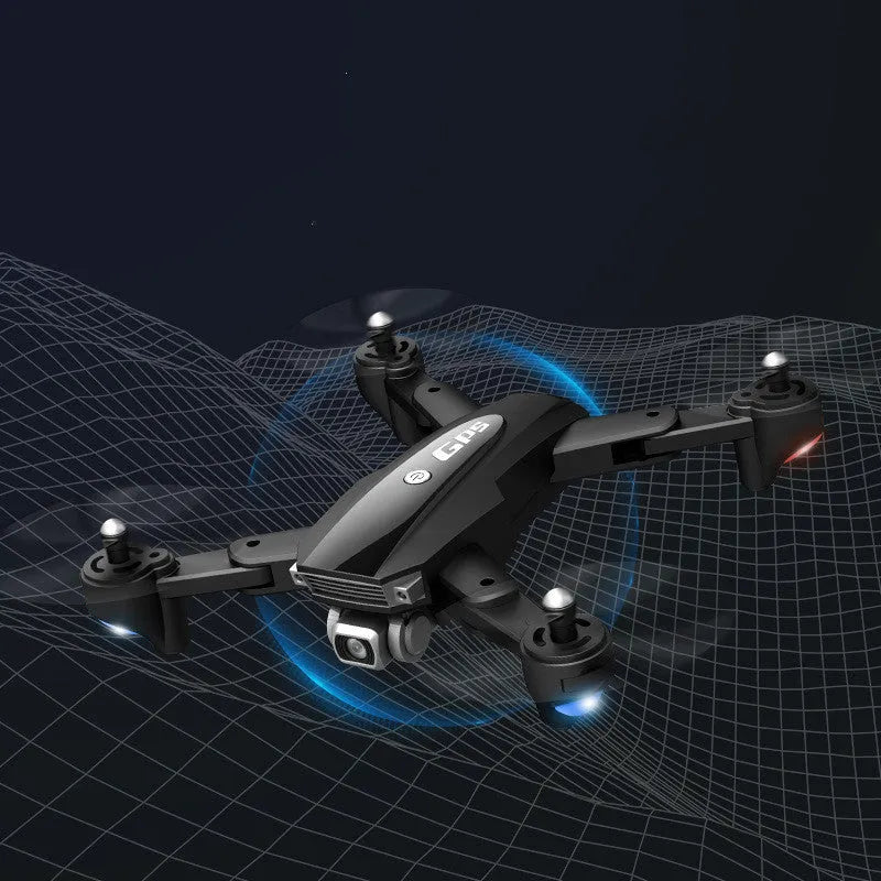 Black and red folding quadrocopter children's toy with 4K camera on a grassy field.