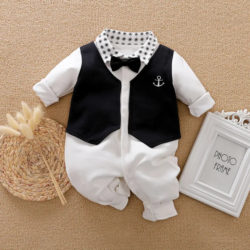 Baby boy wearing a navy blue long-sleeved cotton jumpsuit with gentleman styling.
