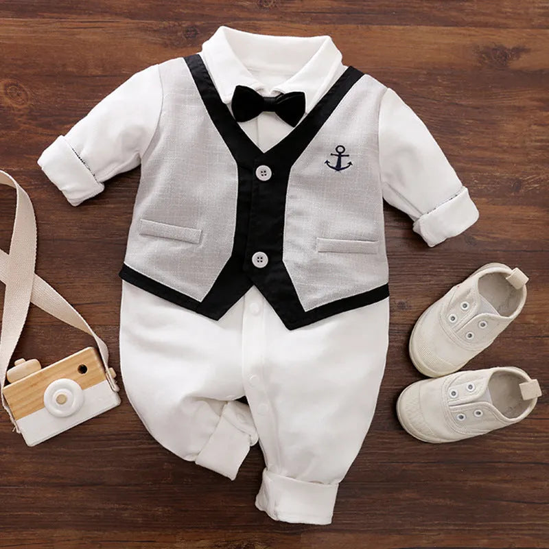 Baby boy wearing a navy blue long-sleeved cotton jumpsuit with gentleman styling.