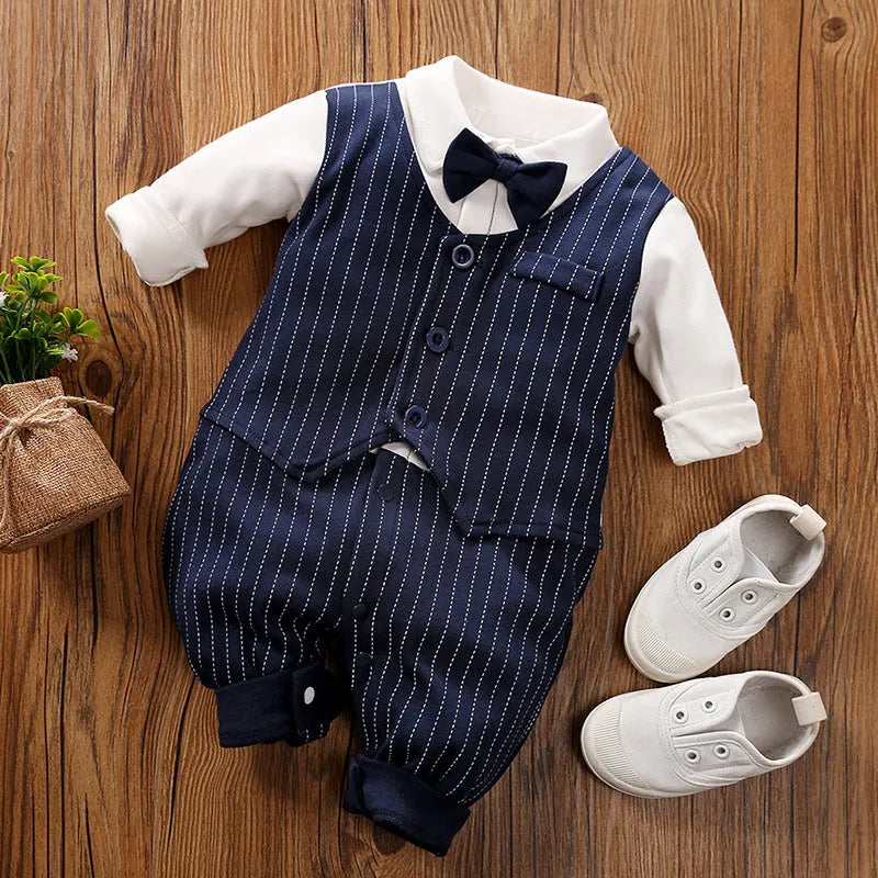 Baby boy wearing a navy blue long-sleeved cotton jumpsuit with gentleman styling.
