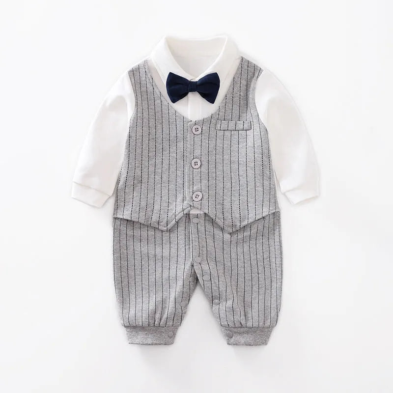 Baby boy wearing a navy blue long-sleeved cotton jumpsuit with gentleman styling.