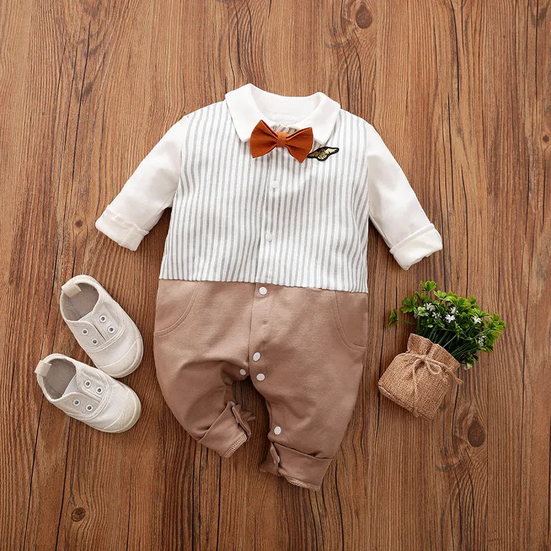Baby boy wearing a navy blue long-sleeved cotton jumpsuit with gentleman styling.