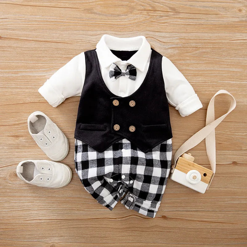 Baby boy wearing a navy blue long-sleeved cotton jumpsuit with gentleman styling.