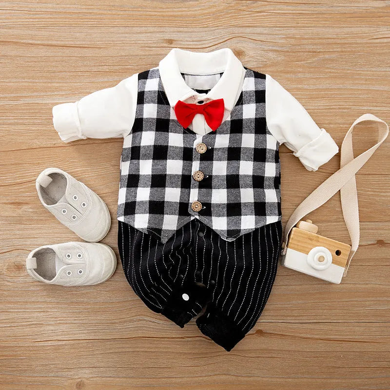 Baby boy wearing a navy blue long-sleeved cotton jumpsuit with gentleman styling.