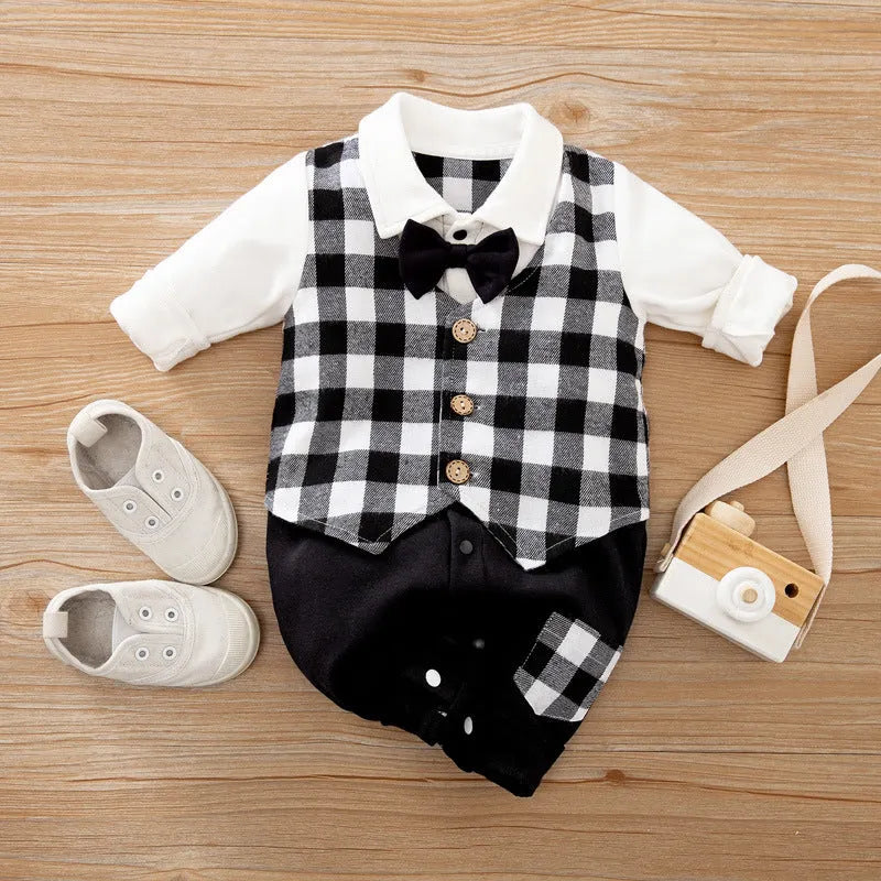 Baby boy wearing a navy blue long-sleeved cotton jumpsuit with gentleman styling.