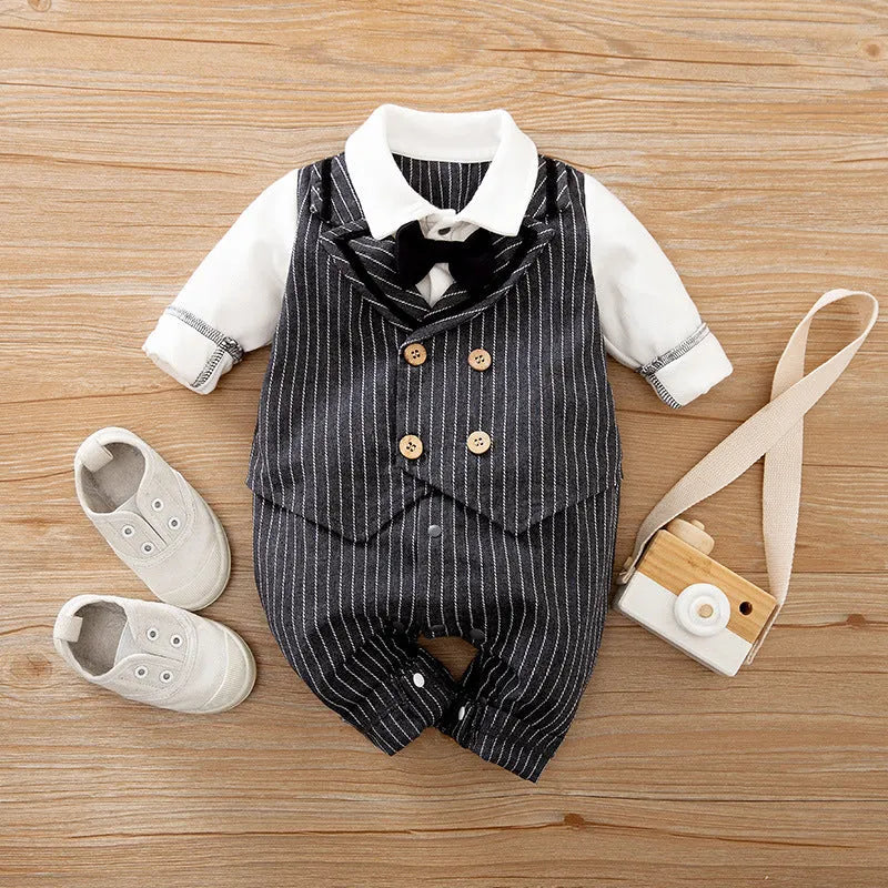 Baby boy wearing a navy blue long-sleeved cotton jumpsuit with gentleman styling.