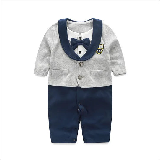 Baby boy wearing a navy blue long-sleeved cotton jumpsuit with gentleman styling.