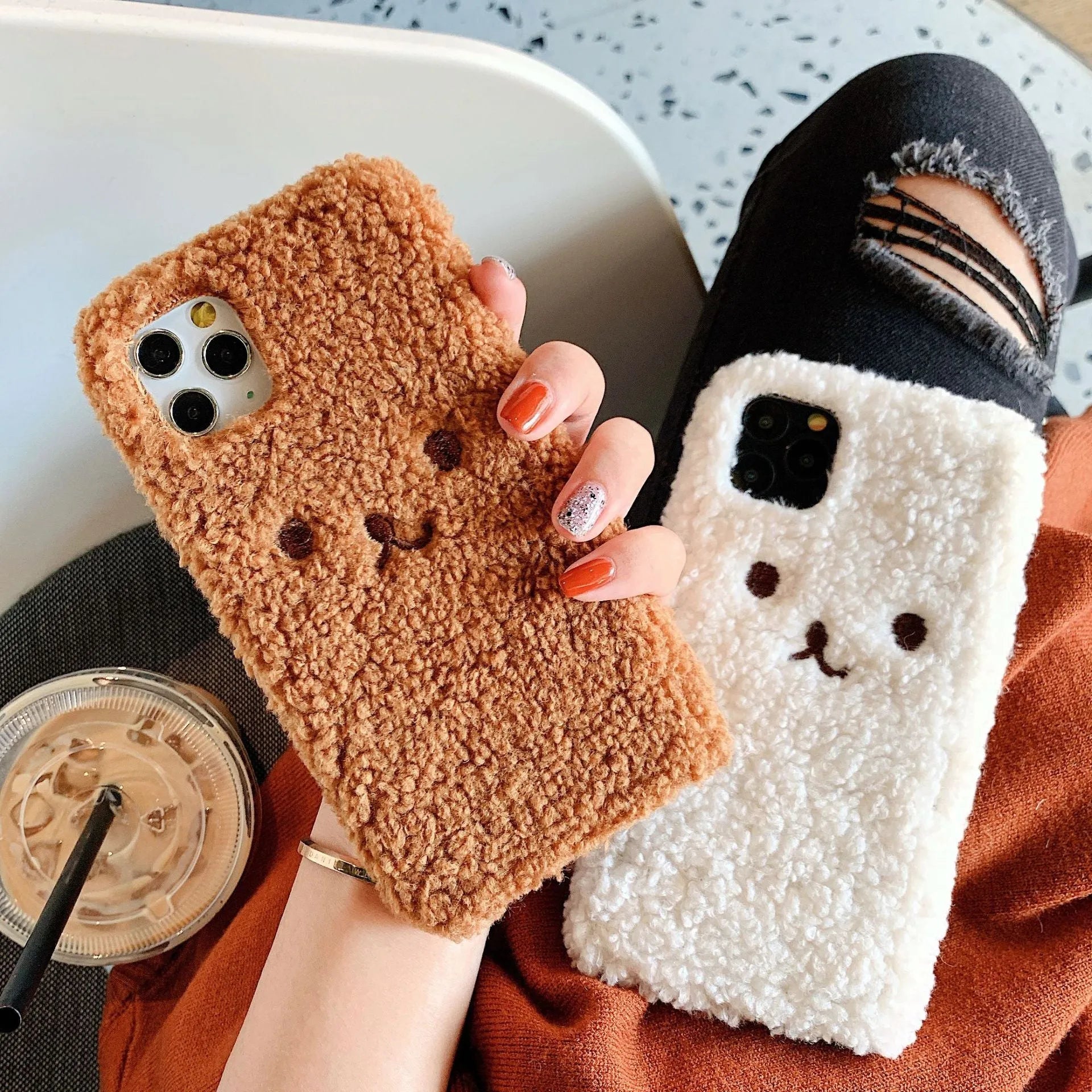 Brown plush embroidered cartoon bear face on a white TPU iPhone case for iPhone 11.