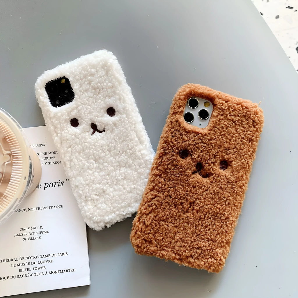 Brown plush embroidered cartoon bear face on a white TPU iPhone case for iPhone 11.