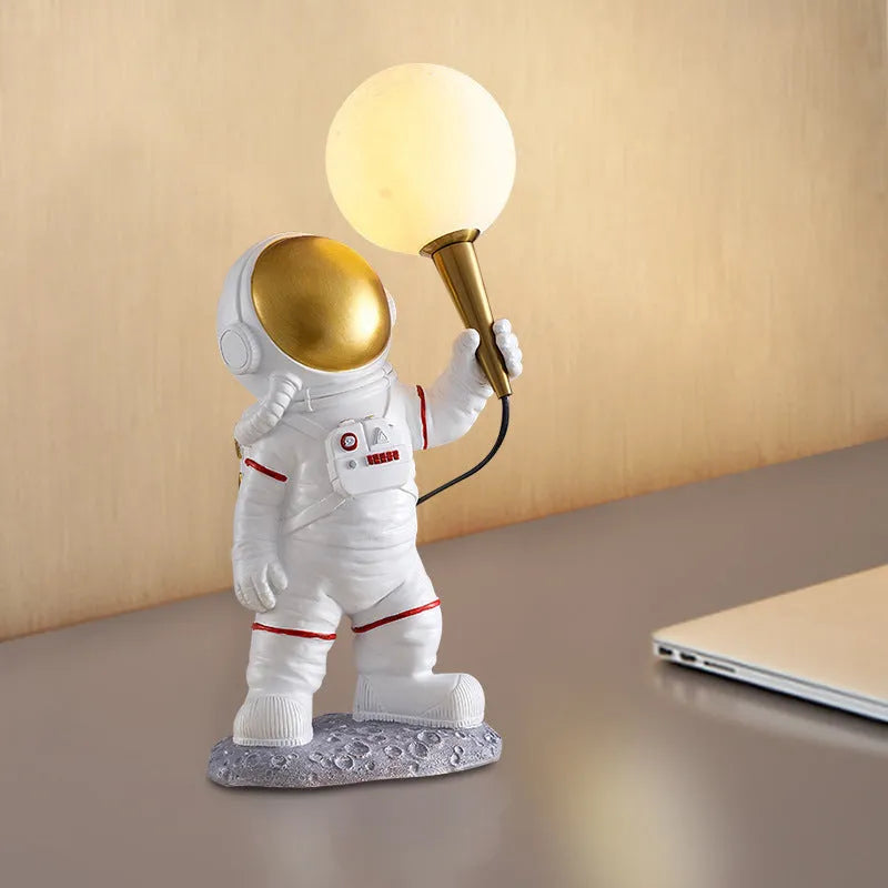 White astronaut desk lamp and children's night light in seated, standing, or wall-mounted style options.