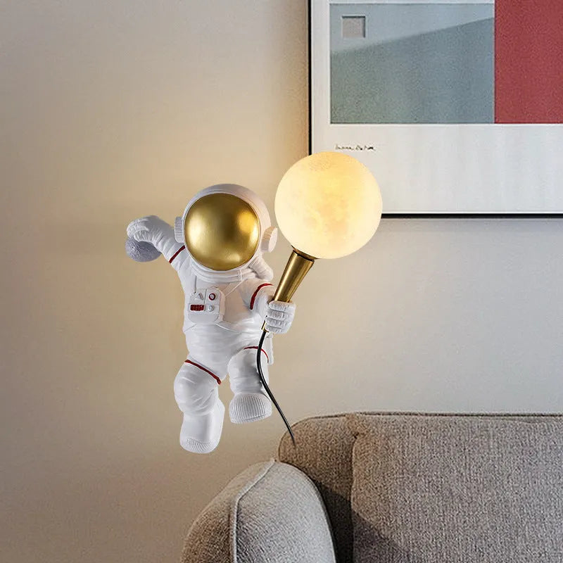 White astronaut desk lamp and children's night light in seated, standing, or wall-mounted style options.