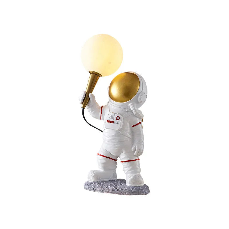 White astronaut desk lamp and children's night light in seated, standing, or wall-mounted style options.