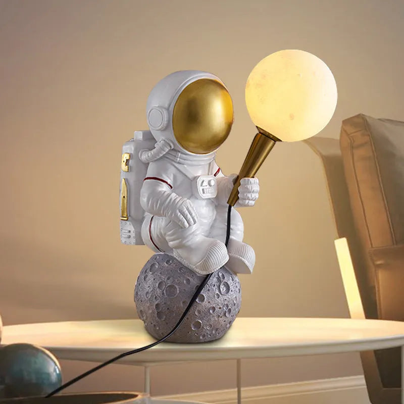 White astronaut desk lamp and children's night light in seated, standing, or wall-mounted style options.